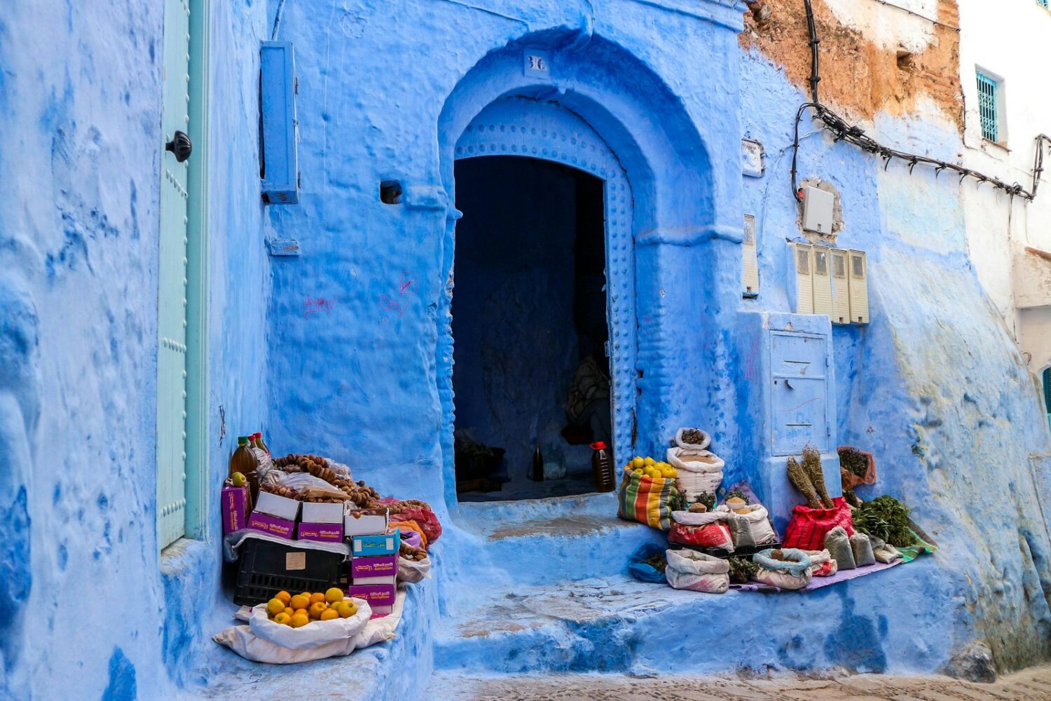 people sitting on blue and white concrete bench during daytime